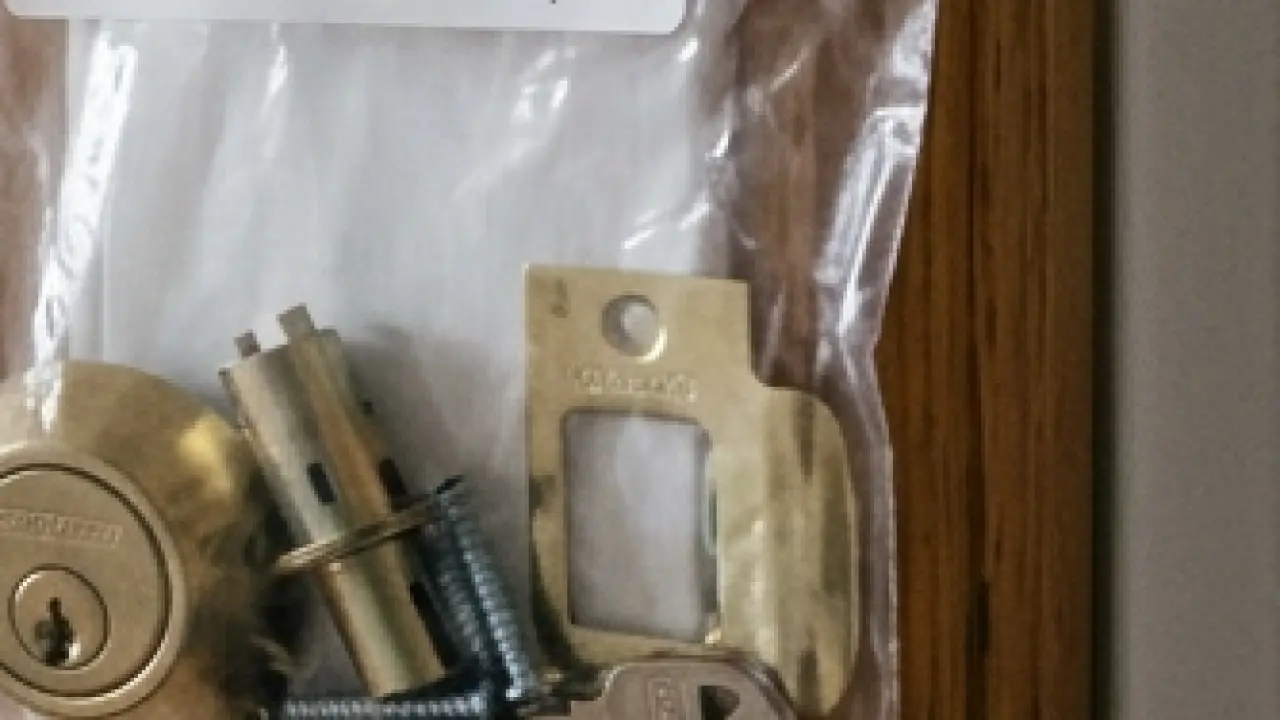 A reinforced strike plate with three-inch screws in a door frame